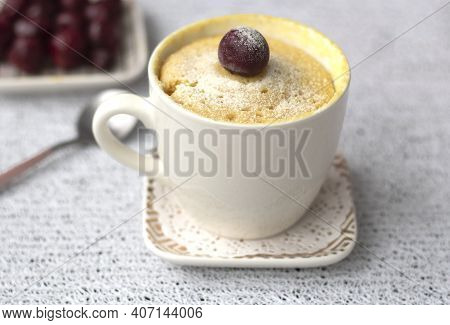 Vanilla Cupcake With Cherries In A Mug. Delicious Sweet Dessert