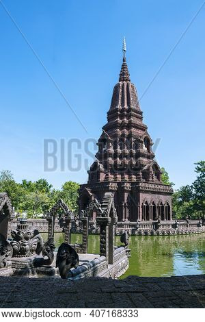 A Beautiful Pagoda In The Middle Of A Pond In A Buddhist Temple In Thailand.