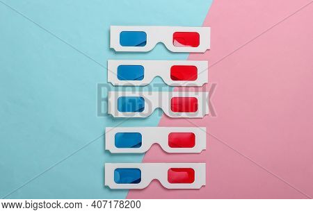 Many Stereoscopic Anaglyph Disposable Paper 3d Glasses On Pink Blue Pastel Background. Top View