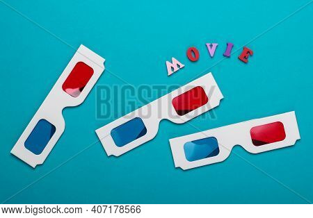 Movie Time. Many Stereoscopic Anaglyph Disposable Paper 3d Glasses On Blue Background. Top View