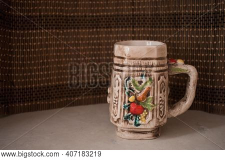 A Colorful Ceramic Empty Mug For Coffee Or Tea With Wicker Background. Home Interior.