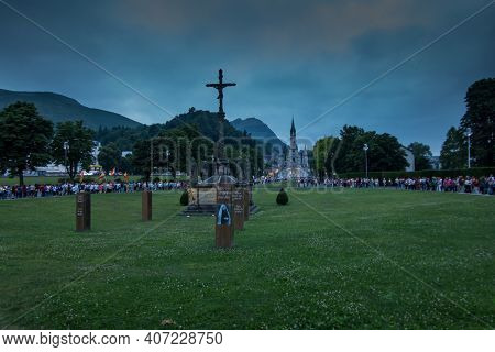 Lourdes, France, 24 June 2019: Evening Procession With Candles At The Shrine Of Lourdes In France