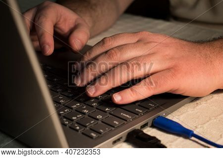 Businessman Hand Typing On Computer Keyboard Of A Laptop Computer. Working From Home And Finance Con