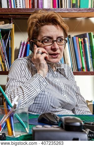 Image Of A Busy Woman Telecommuting At Her Desk At The Home. Working At Home Became An Important Rec