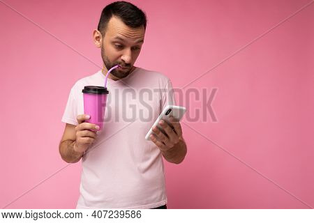 Photo Of Handsome Young Unshaven Brunette Man With Beard Wearing Everyday Light Pink T-shirt Isolate
