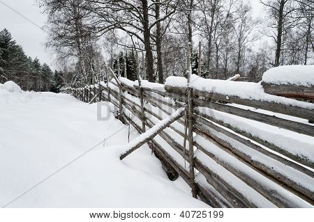 Staccionata in legno rustico, coperto di neve
