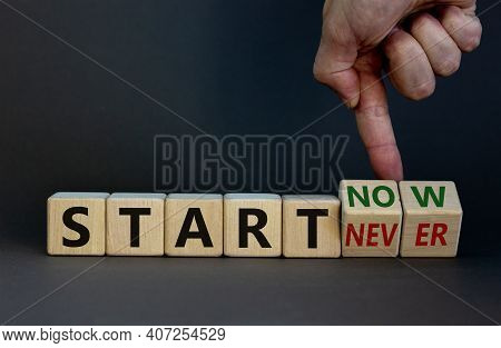 Start Now Or Never Symbol. Businessman Turns Wooden Cubes And Changes Words 'start Never' To 'start 