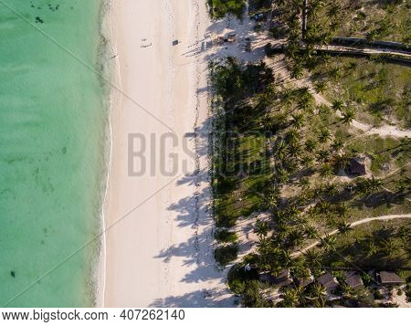Aerial Top View On Paje Beach With Palm Trees Shadows At Evening Time. Paje Village, Zanzibar, Tanza