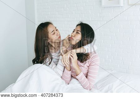 Two Pretty Best Friends Forever Girlfriend Talk, Hug And Laugh Together On Bed At Cozy Home Relation
