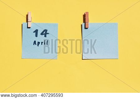 April 14st. Day Of 14 Month, Calendar Date. Two Blue Sheets For Writing On A Yellow Background. Top 