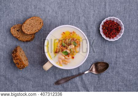 Vegetable Cream Soup With Beans And Spicy Oil In A Bowl On A Textile Background. Selective Focus.