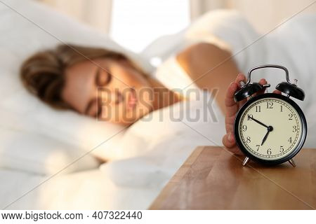 Sleepy Young Woman Stretching Hand To Ringing Alarm Willing Turn It Off. Early Wake Up, Not Getting 