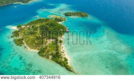 Aerial Drone Of Seascape With Beautiful Beach And Tropical Malipano Island With Palm Trees By Coral 