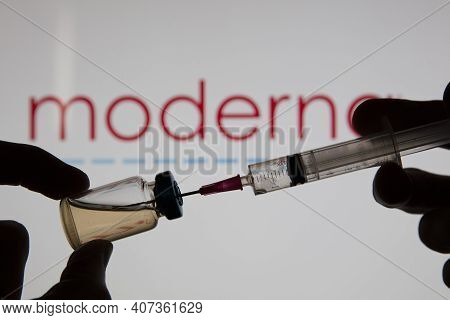 Oxford, Uk - February 2020: A Covid Vaccine Needle Against The Moderna Logo