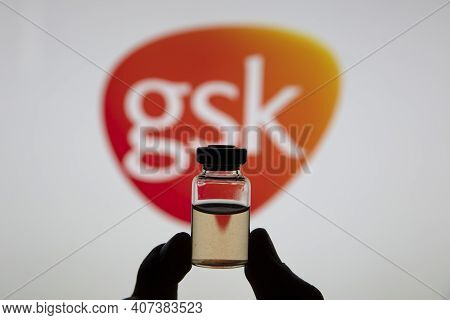 Oxford, Uk - February 2020: Glaxosmithkline Logo With A Bottle Of Covid Vaccine