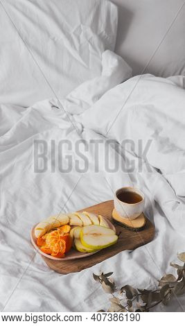 Tray With Fruits And Cup Of Tea In White Clean Bed. Mindful And Quiet Living, Slow Life, Bed In Brea