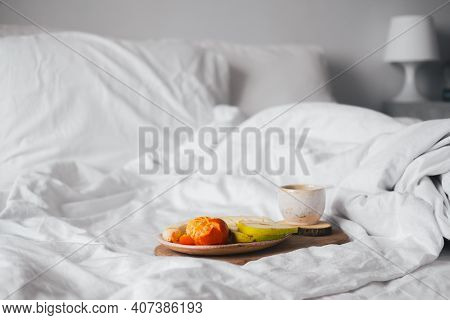 Tray With Fruits And Cup Of Tea In White Clean Bed. Mindful And Quiet Living, Slow Life, Bed In Brea