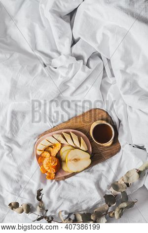 Tray With Fruits And Cup Of Tea In White Clean Bed. Mindful And Quiet Living, Slow Life, Bed In Brea