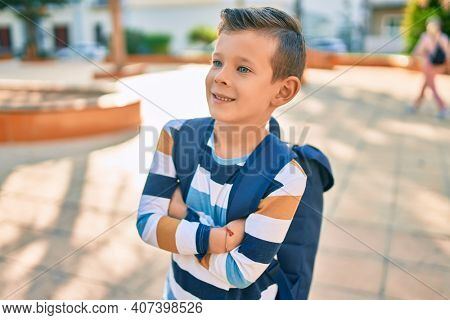 dorable caucasian student boy smiling happy standing at the park.