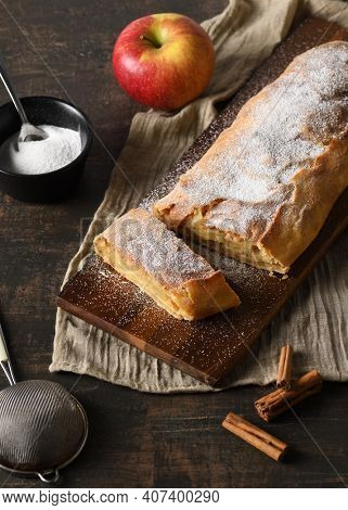 Arrangement of pple strudel with utensils and ingredients