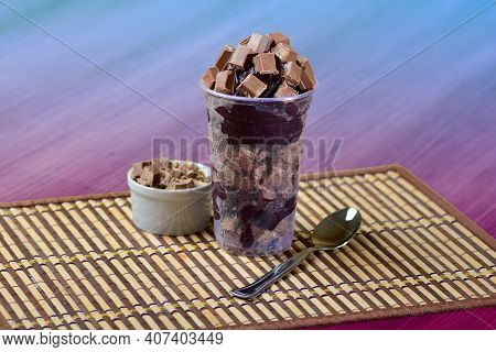 Summer Acai Smoothie With Topping Chocolate. Breakfast Açai Bowl, Cup With Chocolate And Cereal On A