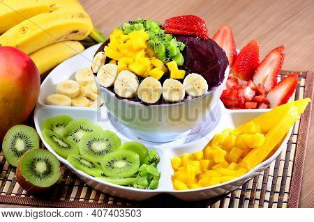Acai Bowl With Fruits Salad Banana Mango Kiwi And Strawberry, Delicious Açaí Brazilian Cream Dessert
