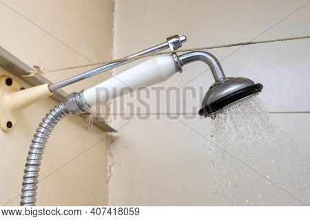 Water Flowing From An Old Shower Head With Ceramic Handle With Limescale Needed To Be Replaced Or De