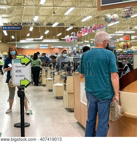 People Waiting In Line To Purchase Lottery Tickets At A Publix Grocery Store