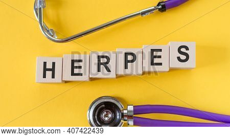 Word Herpes Building From Wooden Cubes On Yellow Desk With Stethoscope.