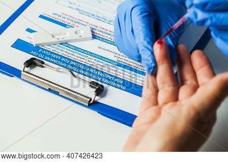 Healthcare Professional Performing Coronavirus Covid-19 Rapid Testing,fingerprick Blood Sample Colle