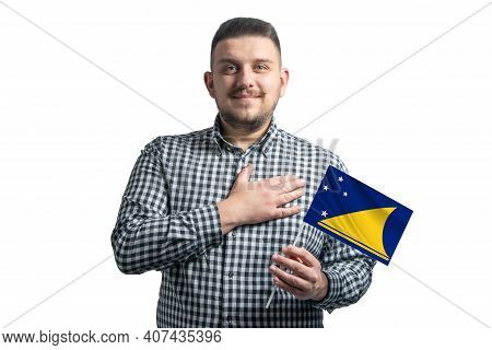 White Guy Holding A Flag Of Tokelau And Holds His Hand On His Heart Isolated On A White Background W