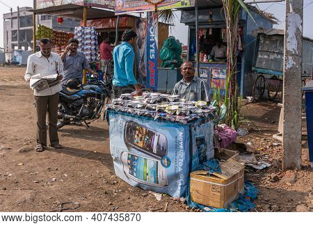 Kolhari, Karnataka, India - November 8, 2013: Roadside Booth Where Male Vendor Sells Home-made Small