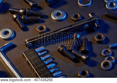 Different Screws, Nuts, Washers, Screwdrivers On Black Background. Hardware Tools And Metal Bolts, N