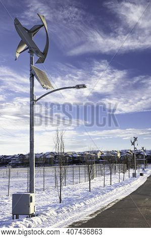 A Modern Vertical Wind Turbine And Solar Panel Produce Renewable Energy In Airdrie Alberta Canada.