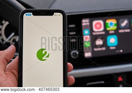 2gis On The Screen Of Smart Phone In Mans Hand On The Background Of Car Dashboard Screen With Applic