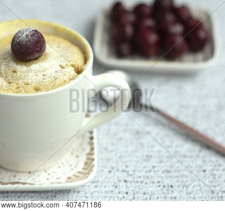 Vanilla Cupcake With Cherries In A Mug. Delicious Sweet Dessert