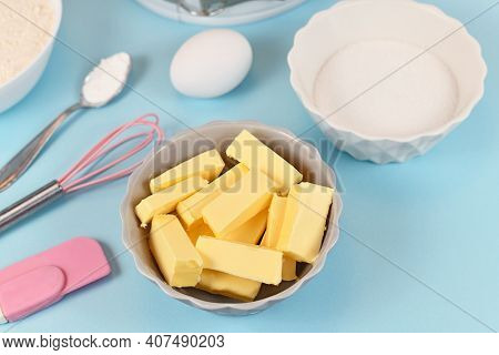 Butter Cut In Pieces For Preparing Dough For Shortcrust Cake Base With Sugar, Egg, Baking Bowder And
