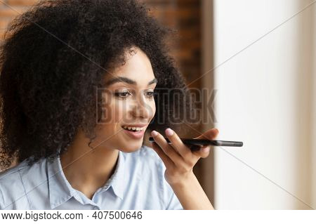 Close-up Of A Young Mixed-race Businesswoman Or A Female Entrepreneur With Afro Hairstyle Holding A 