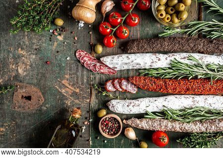 Set Of Spanish Sausages And Dry Cured Meat Chistorra, Chorizo, Salchichon, Fuet, Olives, Rosemary, C