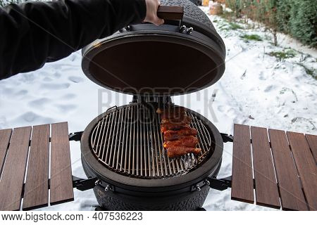 Winter Bbq In The Fresh White Snow, Men Grilling Chicken Wings In The Winter Onn Grill
