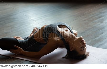 Young Sporty Slim Fit Woman Trainer Do Practice Hatha Yoga Instructor Training Matsyasana Posture Ba