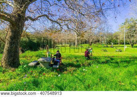 Hagoshrim, Israel - February 09, 2021: View Of Painters, Colorful Anemone Wildflowers, And Trees, In