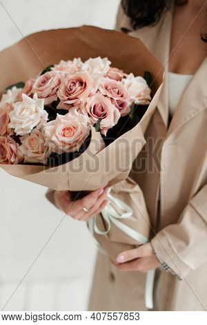 The Girl Is Holding A Bouquet Of Flowers. A Bouquet Of Roses As A Gift. Artificial Bouquet Of Flower