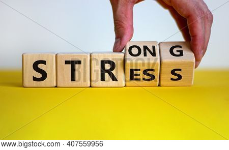 Strong Stress Symbol. Businessman Turns Wooden Cubes With Words 'strong Stress'. Beautiful Yellow Ta