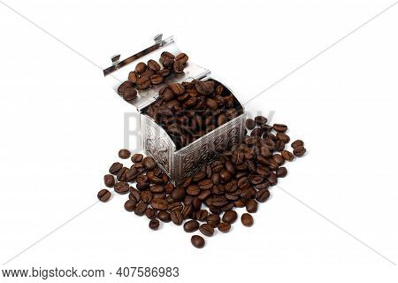 Roasted Coffee Beans In A Small Metal Chest Around It. Isolate On A White Background. Copspace