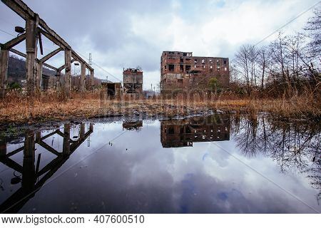 Overgrown Ruins Of Industrial Building. Abandoned, Destroyed By War Coal Processing Factory In Tkvar