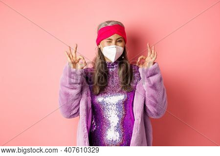 Covid-19, Pandemic And Fashion Concept. Awesome Asian Grandmother Wearing Stylish Disco Dress And Re