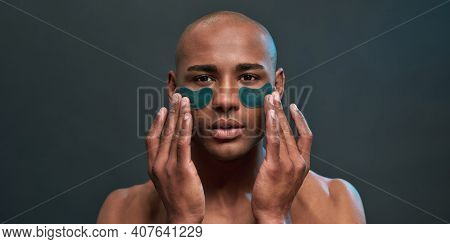 Adult Man Touching Eye Patches With Fingers Of Two Hands And Pressing Them Tighter To Skin