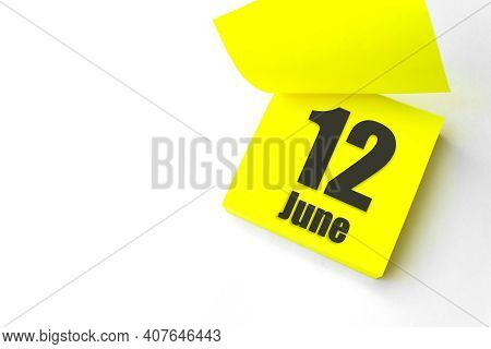 June 12nd. Day 12 Of Month, Calendar Date. Close-up Blank Yellow Paper Reminder Sticky Note On White