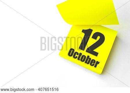 October 12nd. Day 12 Of Month, Calendar Date. Close-up Blank Yellow Paper Reminder Sticky Note On Wh